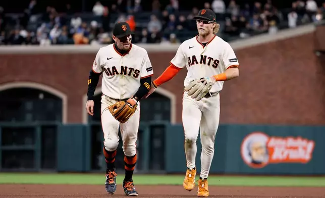 San Francisco Giants shortstop Christian Koss (50) and second baseman Jonah Cox (53) in the 7th inning during an MLB game against the Minnesota Twins at Oracle Park in San Francisco, Monday, Sept. 21, 2026. (Santiago Mejia/San Francisco Chronicle via AP)