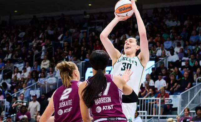 New York Liberty's Breanna Stewart (30) looks to shoot over Toronto Tempo's Laura Juskaite (2) and Isabelle Harrison, front right, during the first half of a WNBA basketball game in Toronto, Sunday, Sept. 20, 2026. (Sammy Kogan/The Canadian Press via AP)