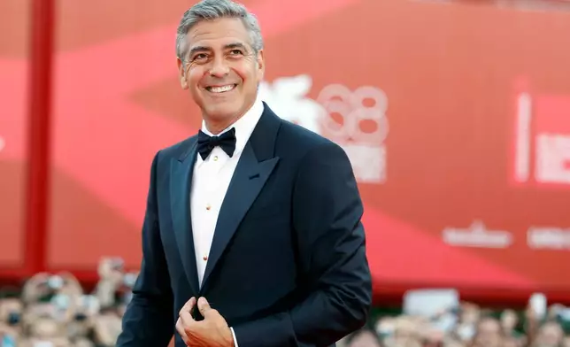 FILE - George Clooney poses on the red carpet at the premiere of his film "The Ides of March," opening the 68th edition of the Venice Film Festival in Venice, Italy on Aug. 31, 2011. (AP Photo/Andrew Medechini, File)