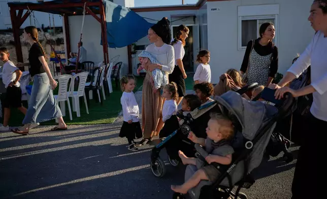 Israeli settlers gather to celebrate the inauguration of a newly built synagogue at the occupied West Bank outpost of Homesh, Wednesday, Sept. 16, 2026. (AP Photo/Ohad Zwigenberg)
