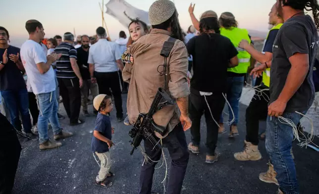 Israeli settlers celebrate the inauguration of a newly built synagogue at the occupied West Bank ilegal outpost of Homesh, Wednesday, Sept. 16, 2026. (AP Photo/Ohad Zwigenberg)