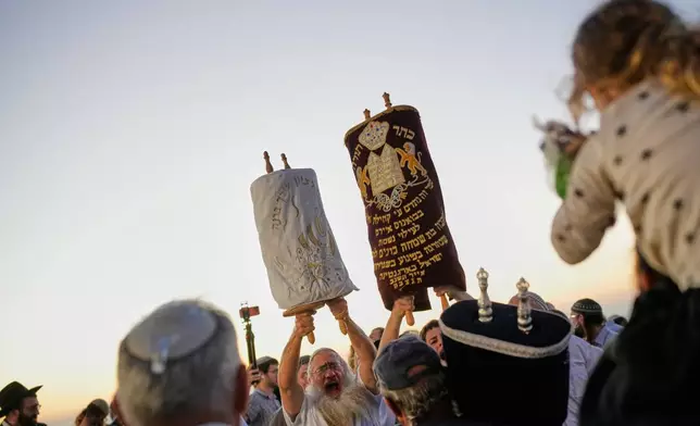 Israeli settlers celebrate the inauguration of a newly built synagogue at the occupied West Bank illegal outpost of Homesh, Wednesday, Sept. 16, 2026. (AP Photo/Ohad Zwigenberg)
