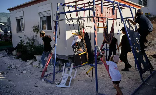Israeli settlers gather to celebrate the inauguration of a newly built synagogue at the occupied West Bank outpost of Homesh, Wednesday, Sept. 16, 2026. (AP Photo/Ohad Zwigenberg)