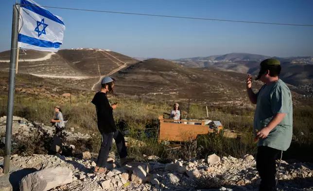 Israeli settlers gather to celebrate the inauguration of a newly built synagogue at the occupied West Bank outpost of Homesh, Wednesday, Sept. 16, 2026. (AP Photo/Ohad Zwigenberg)