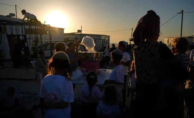 Israeli settlers gather to celebrate the inauguration of a newly built synagogue at the occupied West Bank outpost of Homesh, Wednesday, Sept. 16, 2026. (AP Photo/Ohad Zwigenberg)