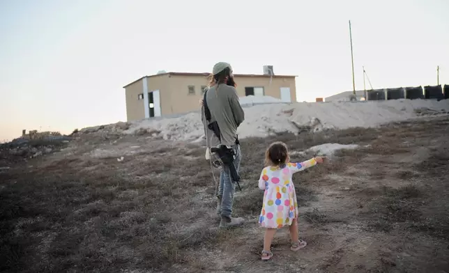 Israeli settlers gather to celebrate the inauguration of a newly built synagogue at the occupied West Bank outpost of Homesh, Wednesday, Sept. 16, 2026. (AP Photo/Ohad Zwigenberg)