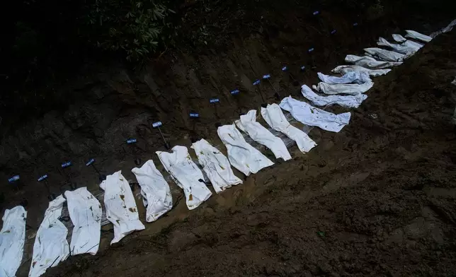 Row of bodies of flash flood victims are laid for mass burial in Kathmandu, Nepal, Tuesday, Sept. 1, 2026. (AP Photo/Niranjan Shrestha)