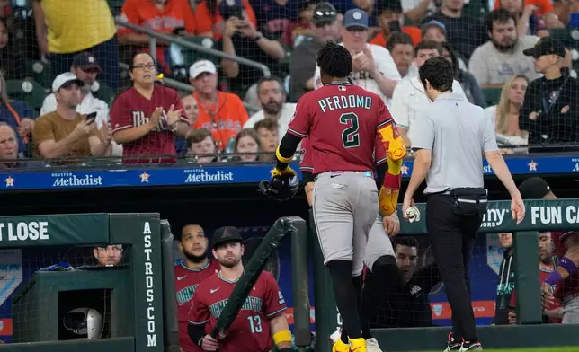 Arizona Diamondbacks' Geraldo Perdomo (2) leaves the game after being hit by a line drive during the third inning of a baseball game against the Houston Astros Sunday, Sept. 6, 2026, in Houston. (AP Photo/David J. Phillip)
