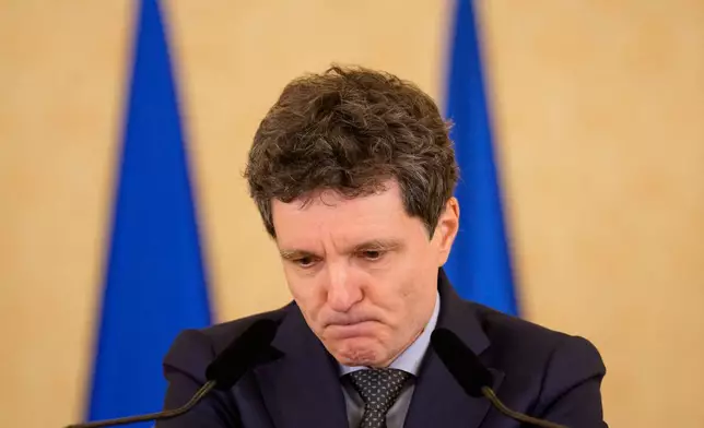 Romanian President Nicusor Dan grimaces while announcing the nomination of European Parliament member Siegfried Muresan as Prime Minister designate in Bucharest, Romania, Thursday, Sept. 17, 2026. (AP Photo/Andreea Alexandru)