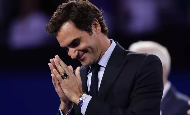 Roger Federer, former tennis player, gestures as he receives his Hall of Fame ring at the U.S. Open tennis championships Monday, Aug. 31, 2026, in New York. (AP Photo/Adam Hunger)