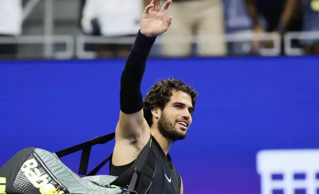 Carlos Alcaraz, of Spain, acknowledges the fans after losing to Ben Shelton, of the United States, in the quarterfinal round of the U.S. Open tennis championships, early Wednesday, Sept. 9, 2026, in New York. (AP Photo/Adam Hunger)