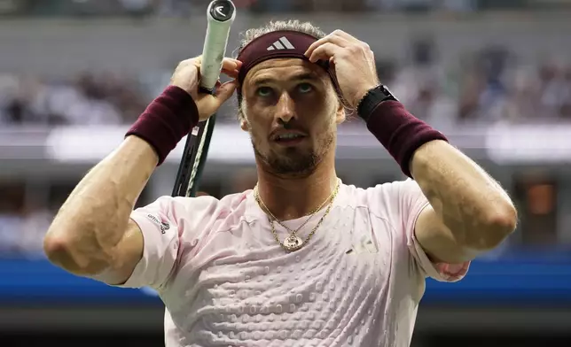 Alexander Zverev, of Germany, adjusts his headband as he competes against Ben Shelton, of the United States, during the men's singles final of the U.S. Open tennis championships Sunday, Sept. 13, 2026, in New York. (AP Photo/Adam Hunger)