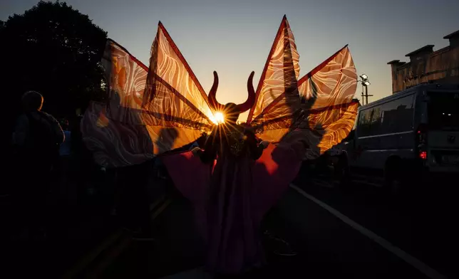 People participate in J'Ouvert festivities ahead of the West Indian Day Parade at sunrise on Labor Day in the Crown Heights and Flatbush neighborhoods of Brooklyn, Monday, Sept. 7, 2026, in New York. (AP Photo/Angelina Katsanis)