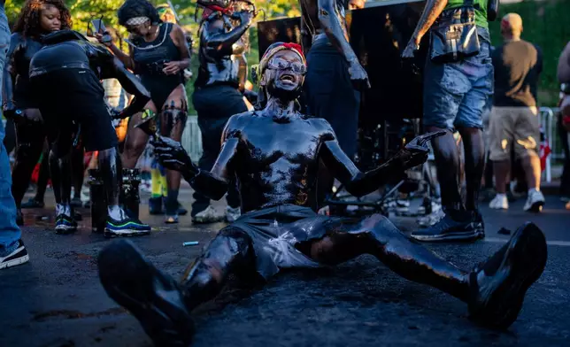 People participate in J'Ouvert festivities ahead of the West Indian Day Parade at sunrise on Labor Day in the Crown Heights and Flatbush neighborhoods of Brooklyn, Monday, Sept. 7, 2026, in New York. (AP Photo/Angelina Katsanis)