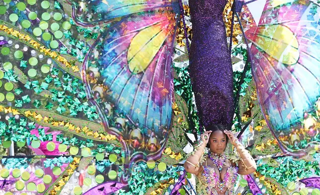 Participants walk in the West Indian Day Parade on Monday, Sept. 7, 2026, in the Brooklyn borough of New York. (AP Photo/Heather Khalifa)