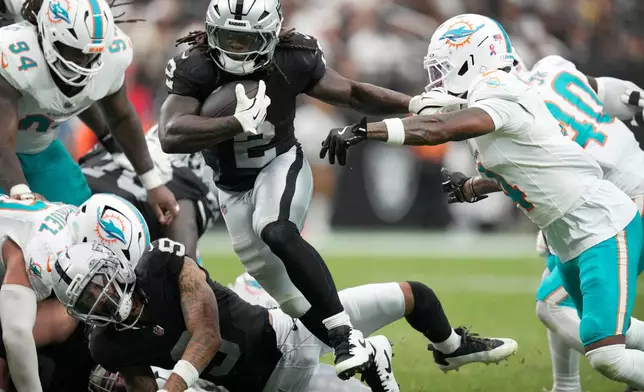 Las Vegas Raiders running back Ashton Jeanty (2) runs from Miami Dolphins cornerback Jason Marshall Jr., right, during the second half of an NFL football game, Sunday, Sept. 13, 2026, in Las Vegas. (AP Photo/Ross D. Franklin)