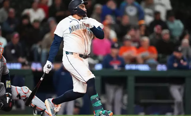 Seattle Mariners' Josh Naylor hits a walk-off RBI single in the 10th inning of a baseball game against the Houston Astros, Wednesday, Sept. 23, 2026, in Seattle. (AP Photo/Lindsey Wasson)