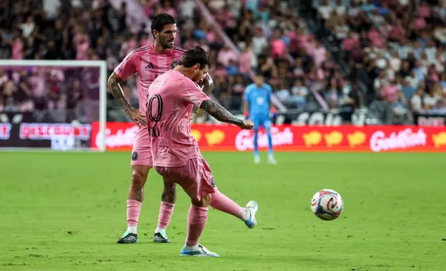 Inter Miami midfielder Rodrigo De Paul, back left, looks on as forward Lionel Messi, front left, shoots and scores on a free kick during the first half of an MLS soccer game against San Diego FC, Sunday, Sept. 20, 2026, in Miami. (AP Photo/David Santiago)