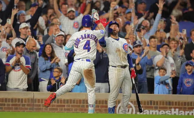 Chicago Cubs' Pete Crow-Armstrong, left, celebrates his home run with teammate Michael Busch, right, during the seventh inning of a baseball game against the Atlanta Braves, Wednesday, Sept. 16, 2026, in Chicago. (AP Photo/Melissa Tamez)