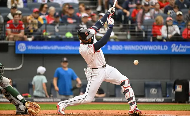 Cleveland Guardians' Jo Adell watches his infield RBI single off Athletics starting pitcher Jack Perkins during the fourth inning of a baseball game, Sunday, Sept. 20, 2026, in Cleveland. (AP Photo/Phil Long)