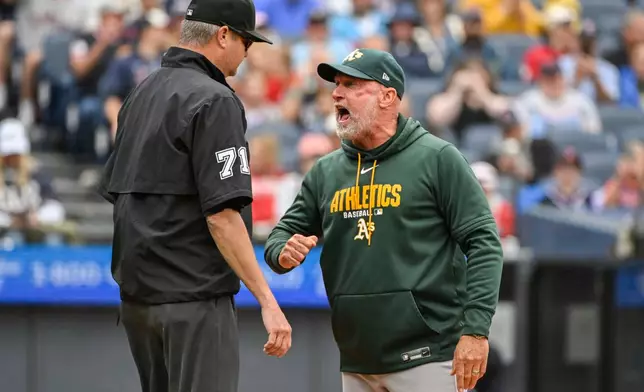 Athletics manager Mark Kotsay, right, argues a call at first base with umpire Jordan Baker, left, during the fourth inning of a baseball game against the Cleveland Guardians, Sunday, Sept. 20, 2026, in Cleveland. (AP Photo/Phil Long)