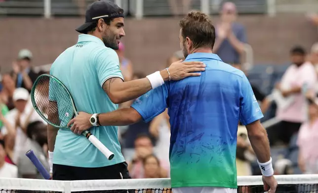 Matteo Berrettini, of Italy, left, greets Stan Wawrinka, of Switzerland, after Berrettini won their match during the first round of the U.S. Open tennis championships Monday, Aug. 31, 2026, in New York. (AP Photo/Adam Hunger)