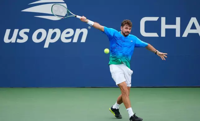 Stan Wawrinka, of Switzerland, returns the ball to Matteo Berrettini, of Italy, during the first round of the U.S. Open tennis championships Monday, Aug. 31, 2026, in New York. (AP Photo/Yuki Iwamura)