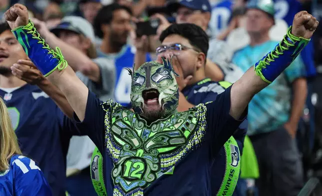 A Seattle Seahawks fan cheers during the second half of an NFL football game against the New England Patriots, Wednesday, Sept. 9, 2026, in Seattle. (AP Photo/Lindsey Wasson)