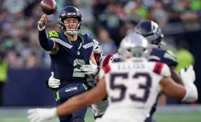 Seattle Seahawks quarterback Drew Lock (2) throws under pressure during the second half of an NFL football game against the New England Patriots, Wednesday, Sept. 9, 2026, in Seattle. (AP Photo/Stephen Brashear)
