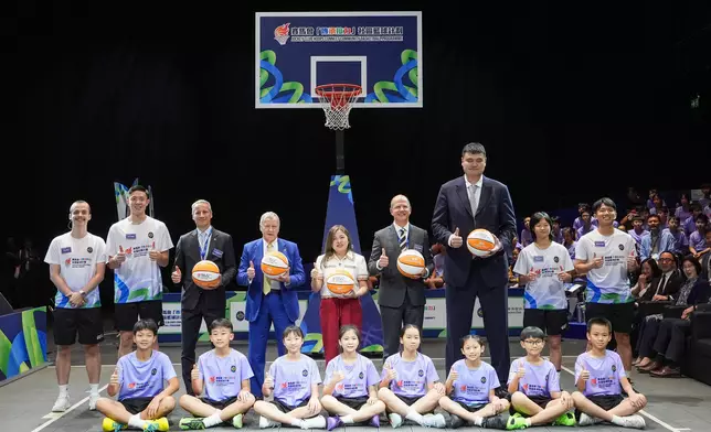 Officiating guests receive commemorative basketballs from youth participants. Photo source: HKJC