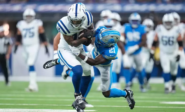 Indianapolis Colts wide receiver Keenan Allen (10) is tackled by Detroit Lions cornerback Roger McCreary (21) during the first half of a preseason NFL football game in Indianapolis, Saturday, Aug. 29, 2026. (AP Photo/Jeff Roberson)