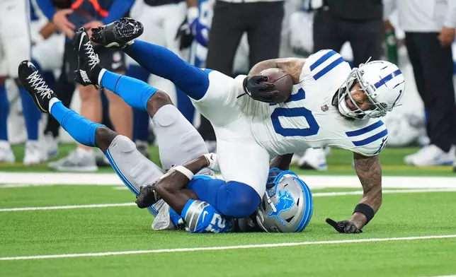 Indianapolis Colts wide receiver Keenan Allen (10) is tackled by Detroit Lions cornerback Roger McCreary (21) during the first half of a preseason NFL football game in Indianapolis, Saturday, Aug. 29, 2026. (AP Photo/AJ Mast)
