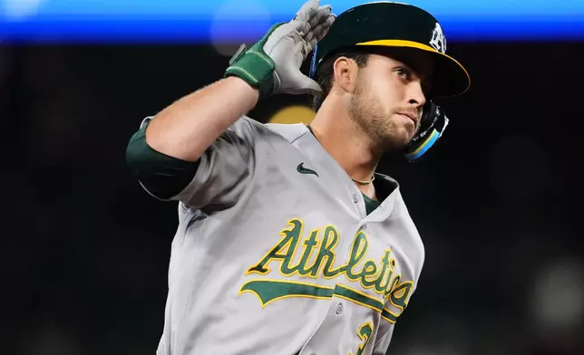 Athletics' Max Muncy reacts as he jogs the bases after hitting a solo home run against the Seattle Mariners during the third inning of a baseball game, Friday, Sept. 4, 2026, in Seattle. (AP Photo/Lindsey Wasson)