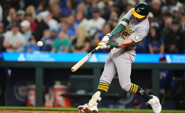 Athletics' Jeff McNeil hits a two-run home run against the Seattle Mariners during the third inning of a baseball game, Friday, Sept. 4, 2026, in Seattle. (AP Photo/Lindsey Wasson)