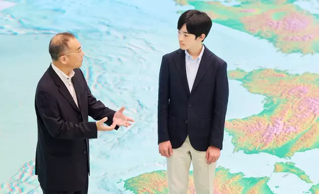 In this photo provided by the Imperial Household Agency of Japan, Japan's Prince Hisahito, right, visits the Science Museum of Map and Survey in Tsukuba, Ibaraki prefecture, Japan, on Aug. 13, 2026, ahead of his 20th birthday on Sept. 6, 2026. (The Imperial Household Agency of Japan via AP)