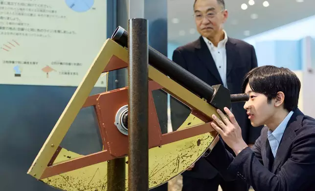 In this photo provided by the Imperial Household Agency of Japan, Japan's Prince Hisahito, right, visits the Science Museum of Map and Survey in Tsukuba, Ibaraki prefecture, Japan, on Aug. 13, 2026, ahead of his 20th birthday on Sept. 6, 2026. (The Imperial Household Agency of Japan via AP)