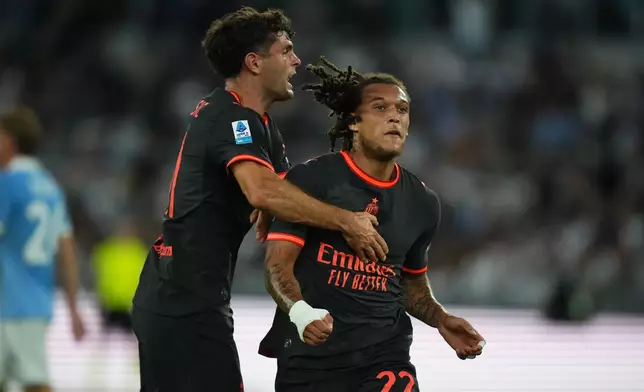 AC Milan's Diego Moreira, right, celebrates after he scored his side's second goal with his teammate Christian Pulisic during a Serie A soccer match between Lazio and AC Milan, in Rome, Saturday, Sept. 12, 2026. (AP Photo/Alessandra Tarantino)