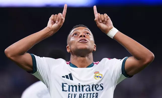 Real Madrid's Kylian Mbappe celebrates scoring his side's 4th goal during the Spanish La Liga soccer match between Real Madrid and Rayo Vallecano in Madrid, Spain, Saturday, Sept. 12, 2026. (AP Photo/Manu Fernandez)