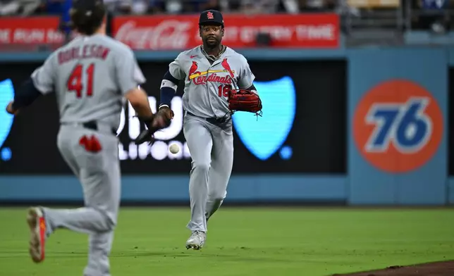 St. Louis Cardinals right fielder Jordan Walker (18) and first baseman Alec Burleson (41) are unable to catch a flyout during the first inning of a baseball game against the Los Angeles Dodgers, Wednesday, Sept. 2, 2026, in Los Angeles. (AP Photo/William Liang)