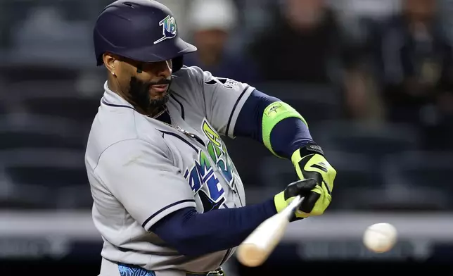 Tampa Bay Rays designated hitter Yandy Díaz hits a two-run scoring single in the ninth inning during the second baseball game of a doubleheader against the New York Yankees, Tuesday, Sept. 22, 2026, in New York. (AP Photo/Adam Hunger)