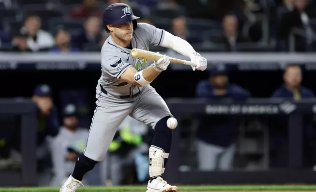 Tampa Bay Rays' Taylor Walls bunts a run scoring single in the seventh inning during the second baseball game of a doubleheader against the New York Yankees, Tuesday, Sept. 22, 2026, in New York. (AP Photo/Adam Hunger)