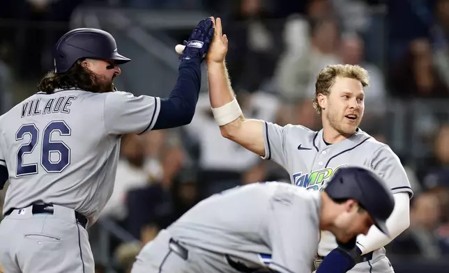Tampa Bay Rays' Taylor Walls celebrates scoring with Ryan Vilade (26) in the seventh inning during the second baseball game of a doubleheader against the New York Yankees, Tuesday, Sept. 22, 2026, in New York. (AP Photo/Adam Hunger)