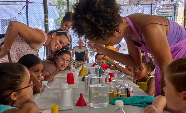 Children attend a workshop to make gift bags and perfume in Havana, Cuba, Friday, Aug. 28, 2026. (AP Photo/Ramon Espinosa)