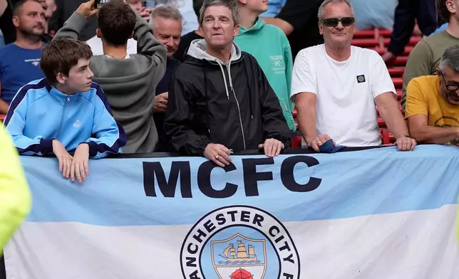 Manchester City supporter Noel Gallagher in the waits stands after the English Premier League soccer match against Manchester United in Manchester, England, Sunday Sept. 13, 2026. (Peter Byrne/PA via AP)