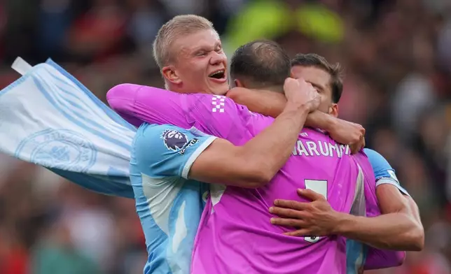 Manchester City's Erling Haaland, left, Manchester City's goalkeeper Gianluigi Donnarumma, Manchester City's Ruben Dias celebrate after the English Premier League soccer match between Manchester United and Manchester City in Manchester, England, Sunday, Sept. 13, 2026. (AP Photo/Ian Hodgson)