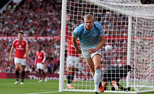 Manchester City's Erling Haaland celebrates after scoring his sides first goal during the English Premier League soccer match against Manchester United in Manchester, England, Sunday Sept. 13, 2026. (Peter Byrne/PA via AP)