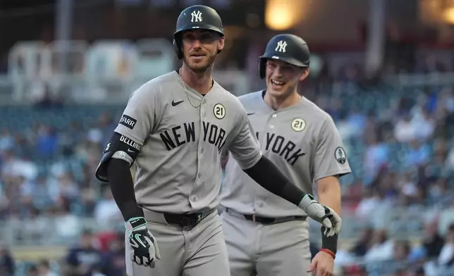 New York Yankees left fielder Cody Bellinger, front, jogs toward the dugout after crossing home plate after hitting a 2-run home run during the first inning of a baseball game against the Minnesota Twins Tuesday, Sept. 15, 2026, in Minneapolis. (AP Photo/Abbie Parr)