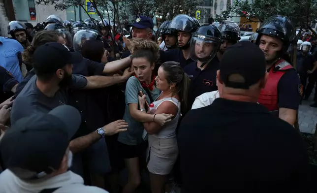 Police officers clash with protesters during ongoing demonstrations against plans for a luxury resort in a protected coastal area linked to Jared Kushner, U.S. President Donald Trump's son-in-law, in Tirana, Albania, Tuesday, Sept. 8, 2026. (AP Photo/Hameraldi Agolli)