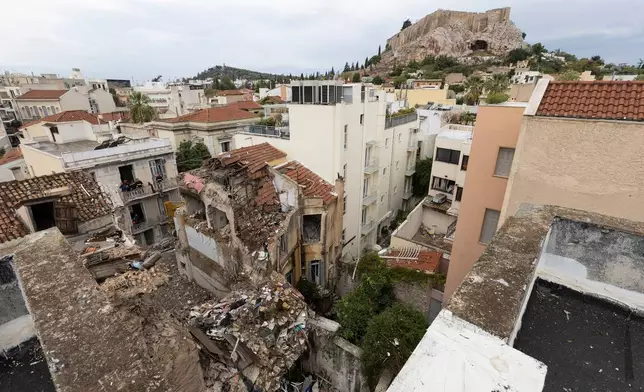 A general view of the area where a powerful blast caused a building to collapse and injured a few people in Athens' Plaka district, Saturday, Sept. 26, 2026. (AP Photo/Yorgos Karahalis)