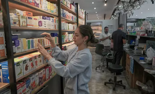 A pharmacy technician arranges boxes of medicine at a pharmacy in Tehran, Iran, Monday, Sept. 21, 2026. (AP Photo/Vahid Salemi)